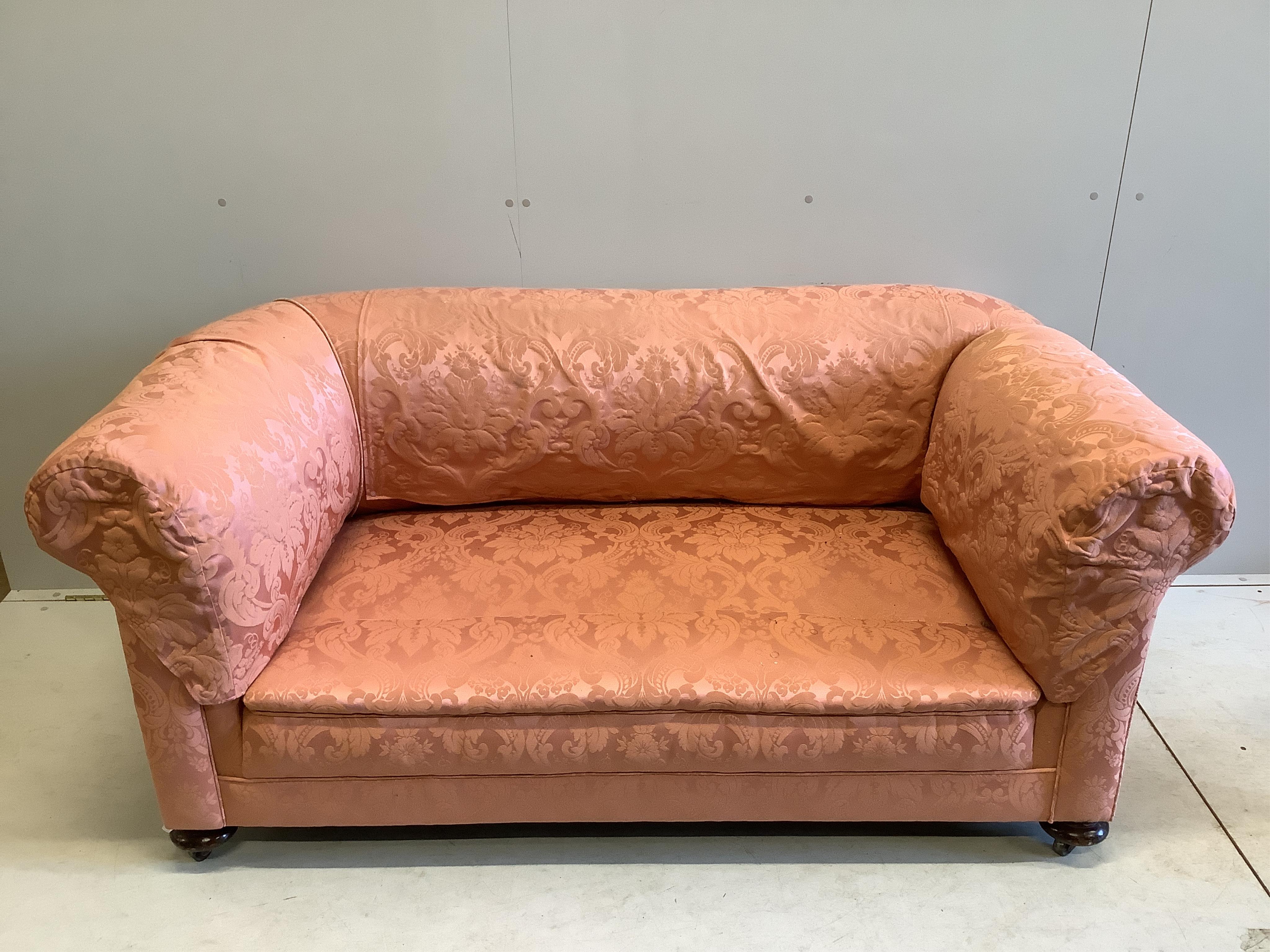 An early 20th century upholstered drop arm Chesterfield settee, width 166cm, depth 90cm, height 74cm. Condition - good